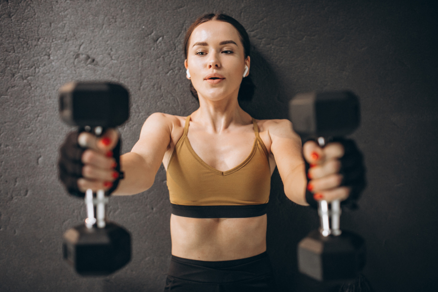 women doing exercise with dumbbell