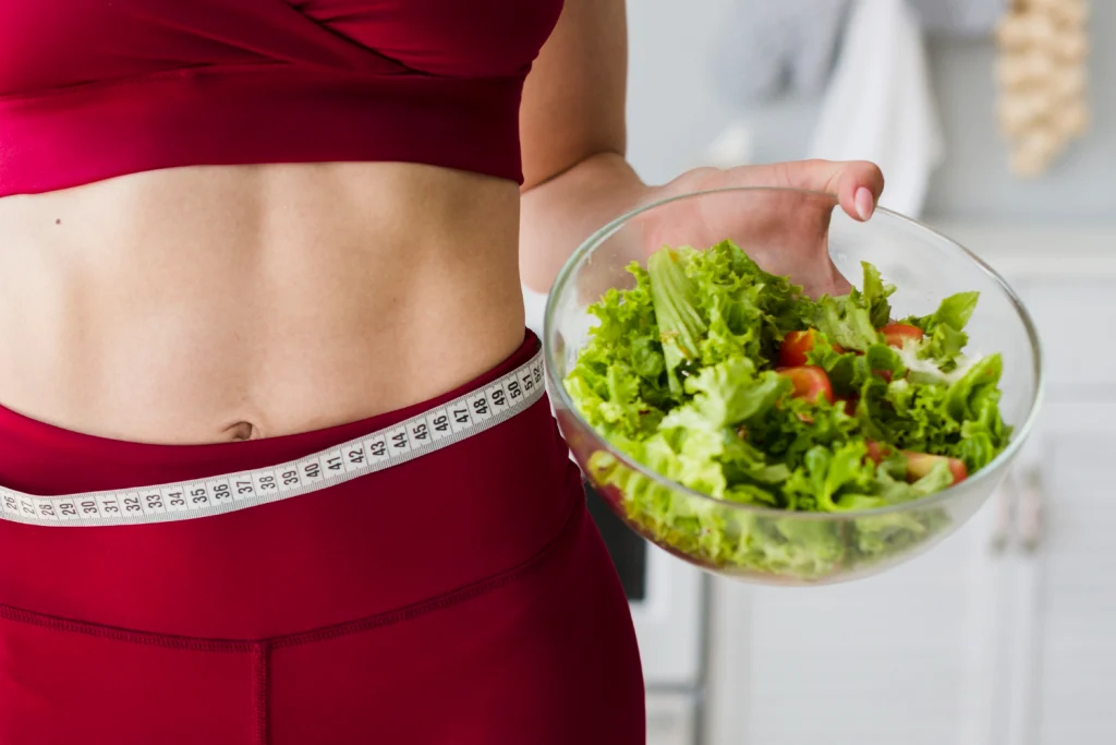 women holding a plate full of vegetables